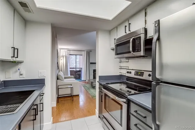 a kitchen with stainless steel appliances granite countertop a stove and a refrigerator