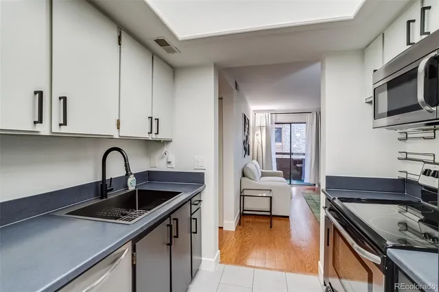 a kitchen with stainless steel appliances granite countertop a sink and cabinets