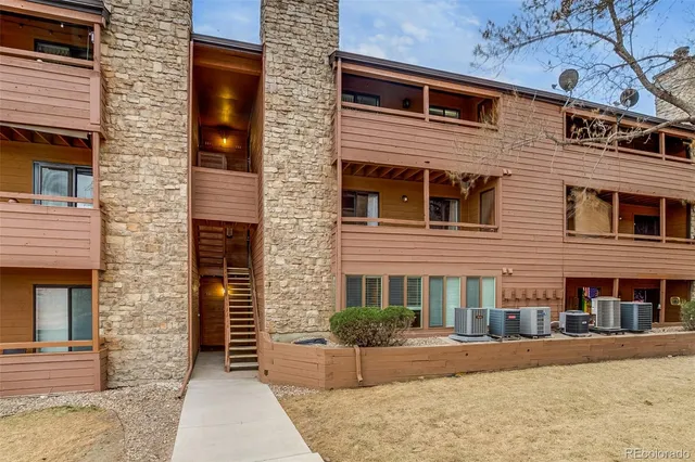a front view of a brick house with a yard