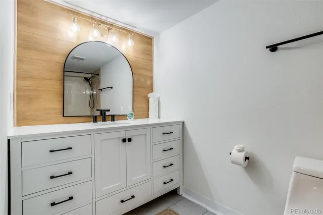 a bathroom with a double vanity sink and a mirror