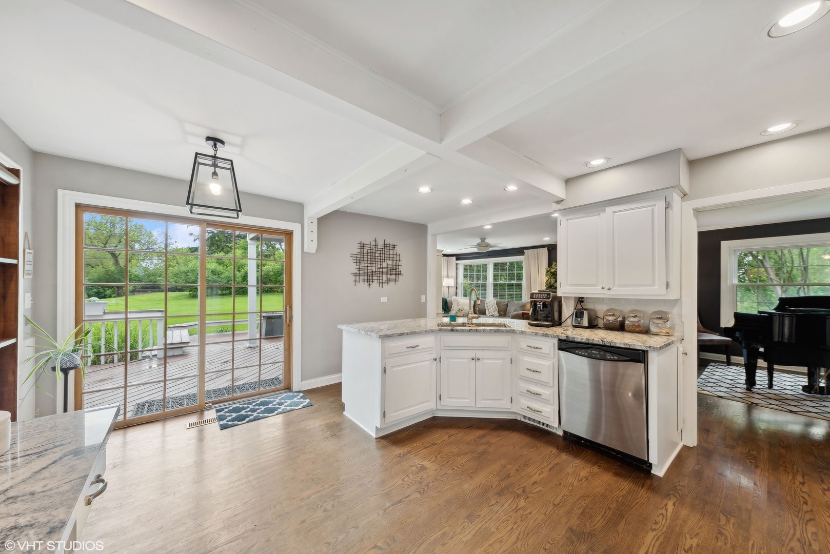 224 Orchard Road North Barrington, IL 60010 - Photo 13 of 34 a kitchen with granite countertop a stove a sink a dining table and chairs with wooden floor