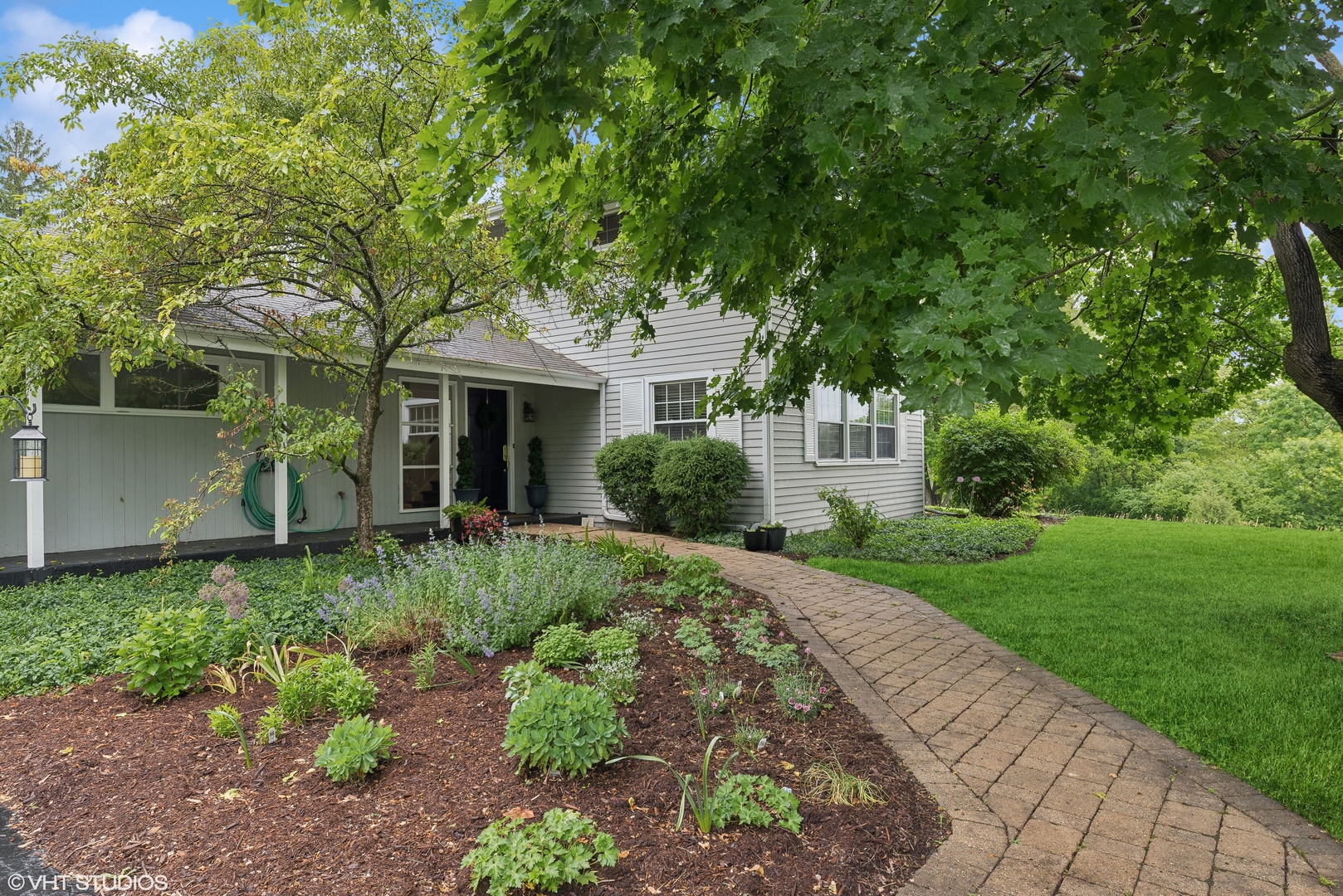 224 Orchard Road North Barrington, IL 60010 - Photo 3 of 34 a front view of a house with a yard and a garden