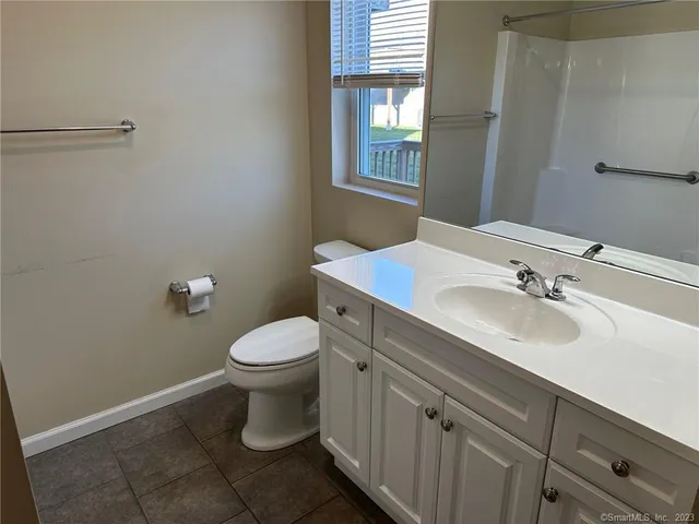 a bathroom with a sink toilet and window