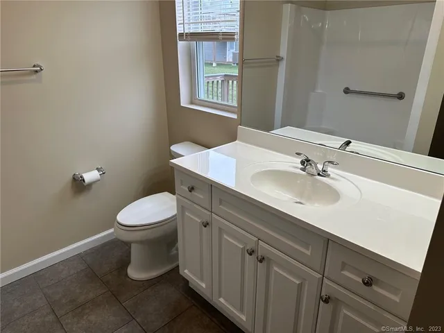 a bathroom with a sink toilet and a mirror