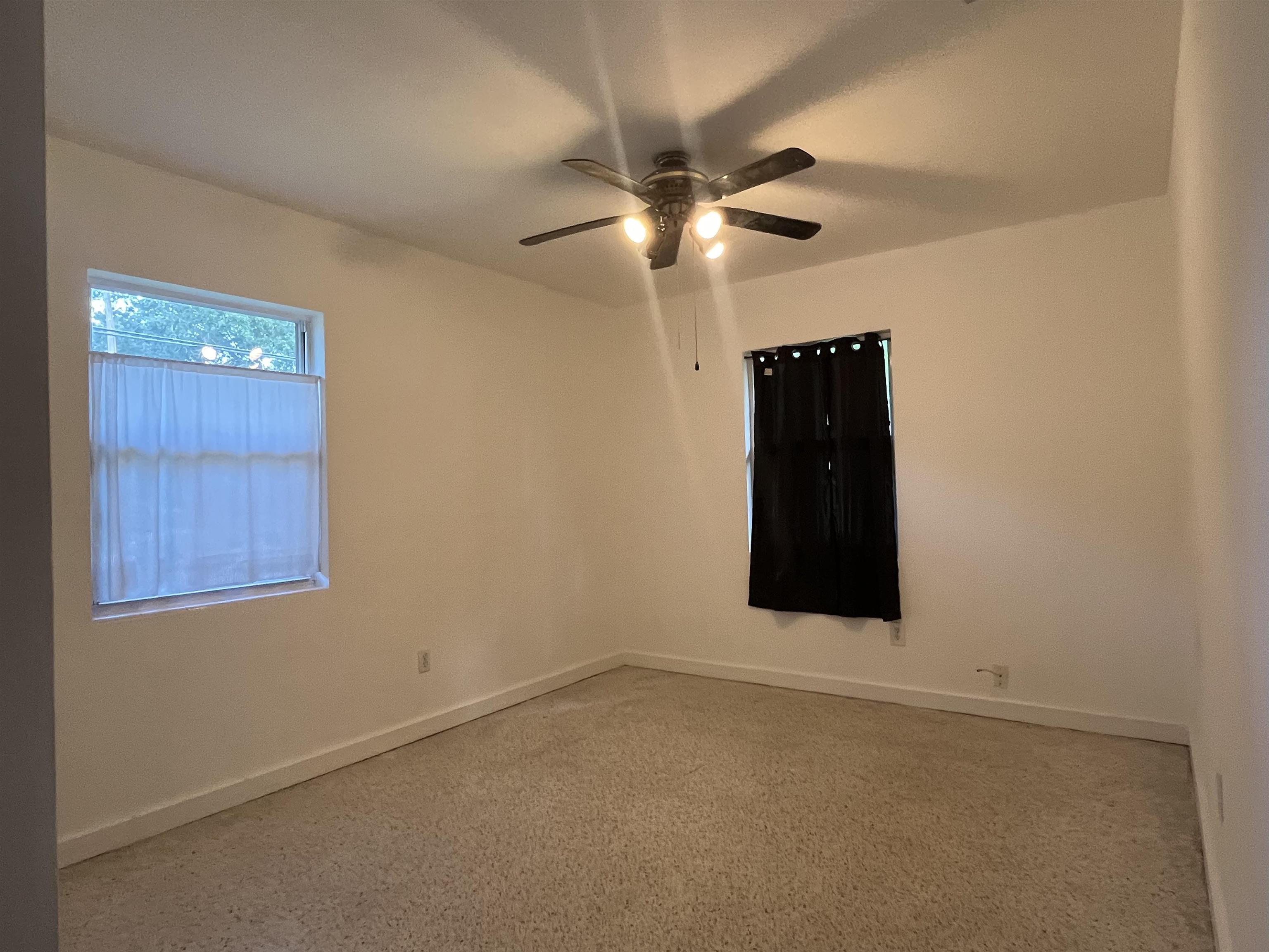 58 Riberia Street St. Augustine, FL 32084 - Photo 13 of 20 en empty room with windows and fan