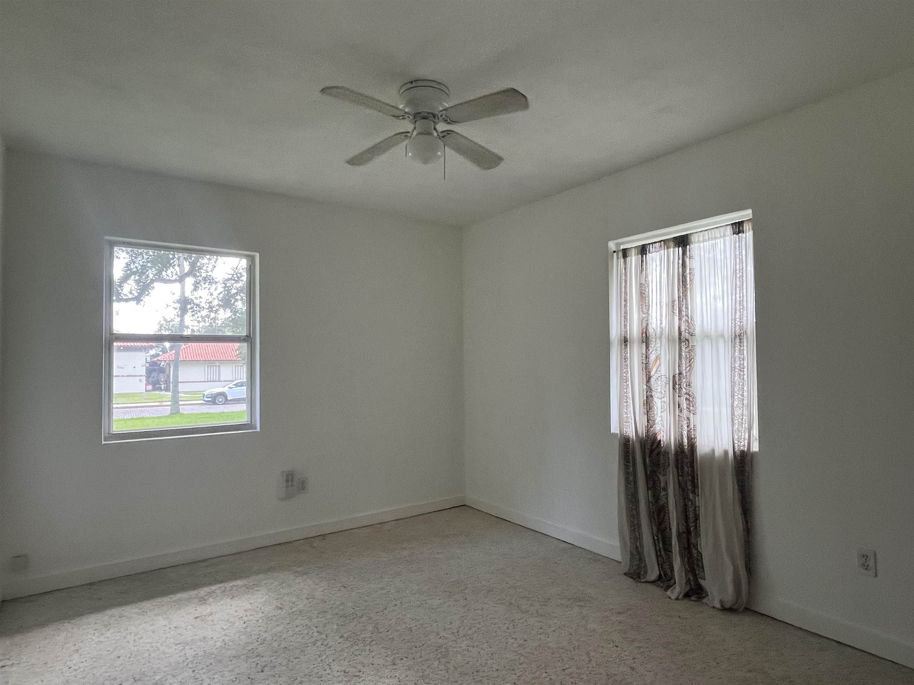58 Riberia Street St. Augustine, FL 32084 - Photo 14 of 20 an empty room with windows and closet