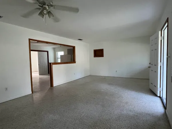 an empty room with a empty space and windows