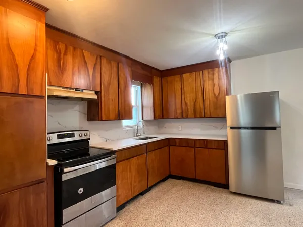 a kitchen with a sink a stove and refrigerator