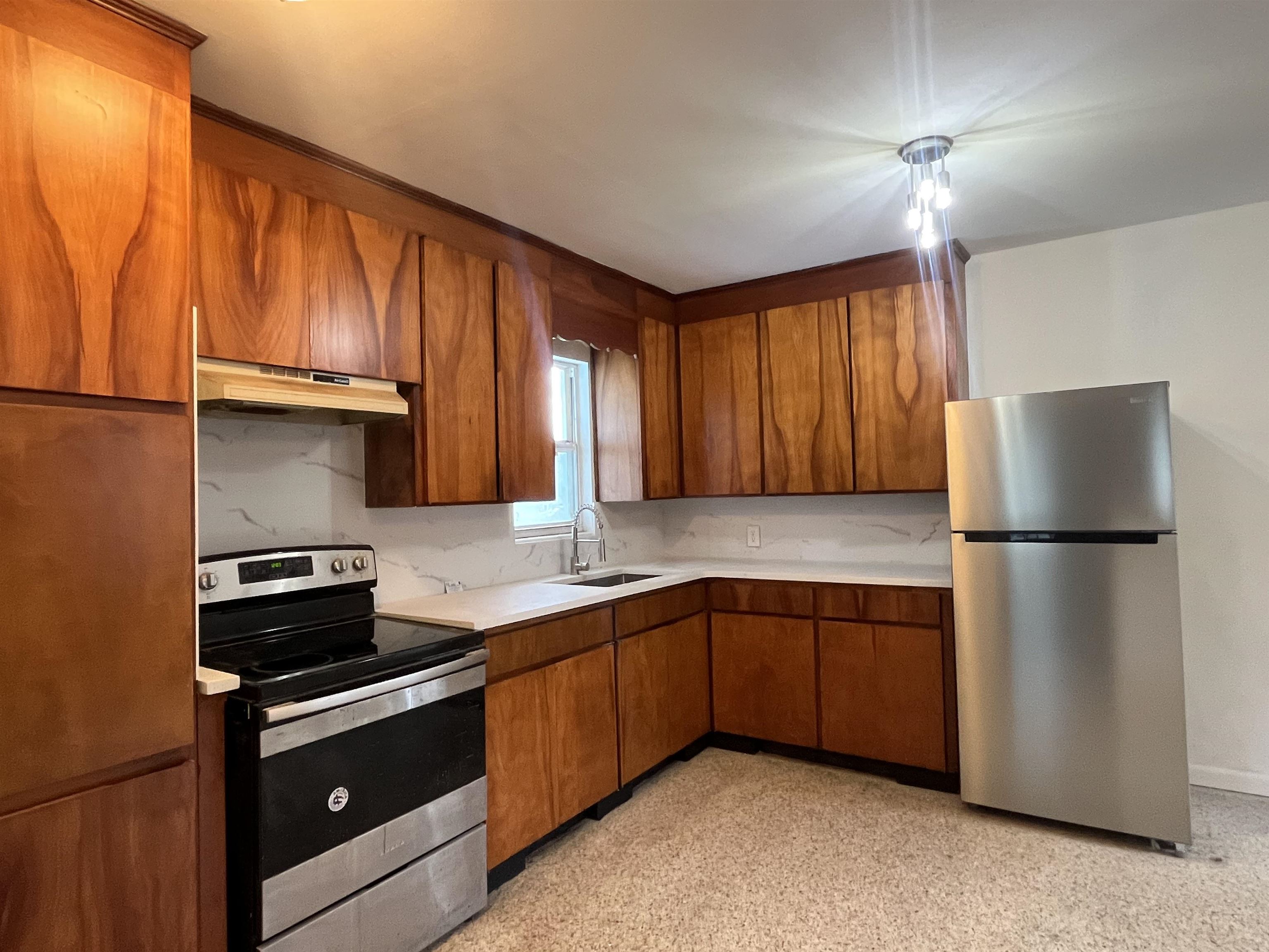 58 Riberia Street St. Augustine, FL 32084 - Photo 7 of 20 a kitchen with a sink a stove and refrigerator