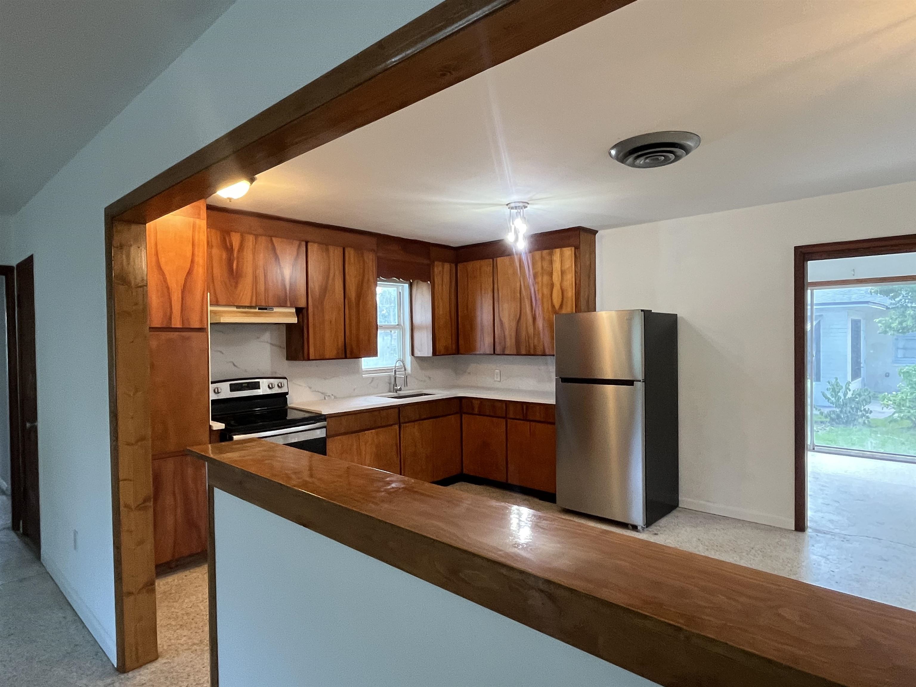 58 Riberia Street St. Augustine, FL 32084 - Photo 9 of 20 a kitchen with a refrigerator a microwave a sink and cabinets