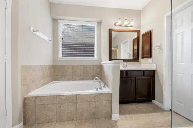 a bathroom with a bathtub and a sink