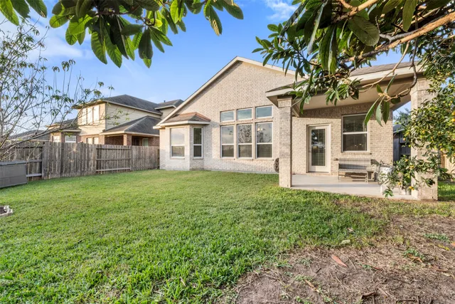 a view of a house with a backyard