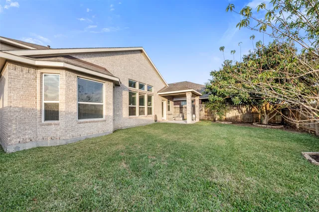 a view of a house with a backyard