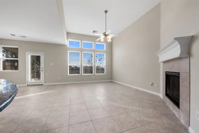 a view of an empty room with a fireplace and a window