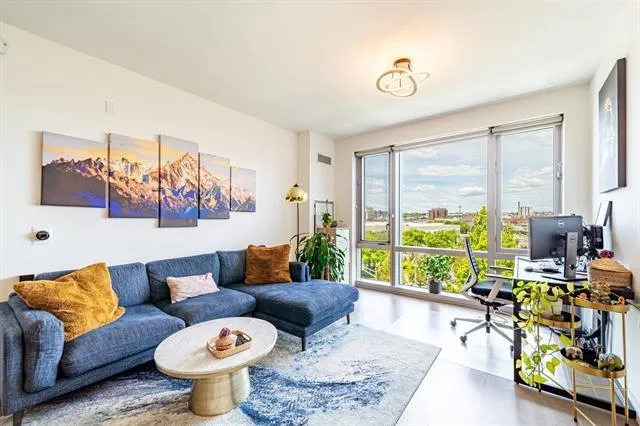 a living room with furniture and a large window