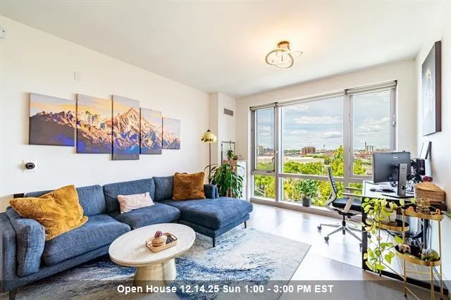 a living room with furniture and a floor to ceiling window