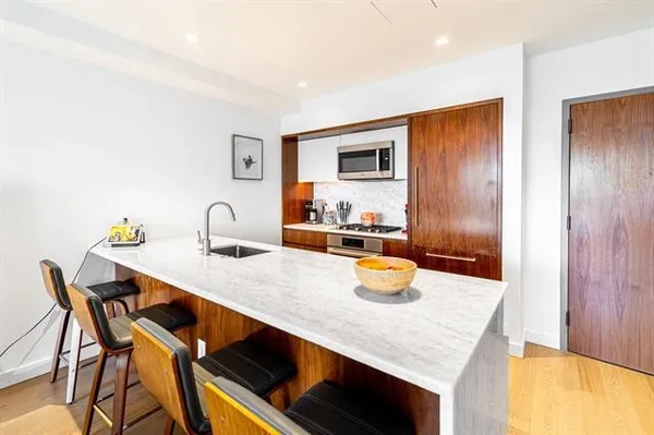 a kitchen with a wooden table and chairs