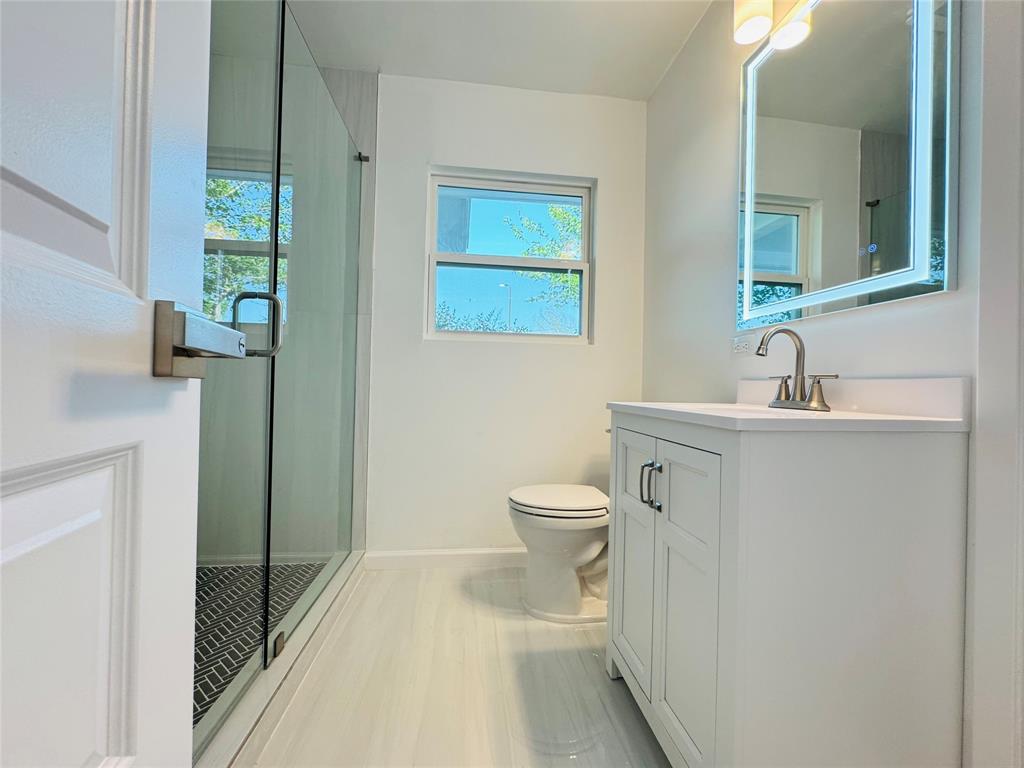 106 Hillcrest Street Mansfield, TX 76063 - Photo 24 of 26 a bathroom with a toilet sink and mirror