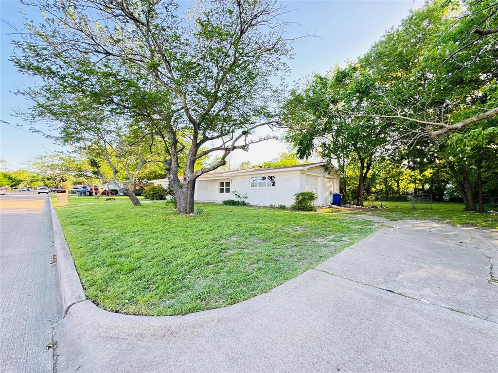 106 Hillcrest Street Mansfield, TX 76063 - Photo 3 of 26 a view of a house with a backyard