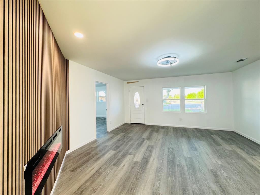 106 Hillcrest Street Mansfield, TX 76063 - Photo 8 of 26 wooden floor in an empty room with a window