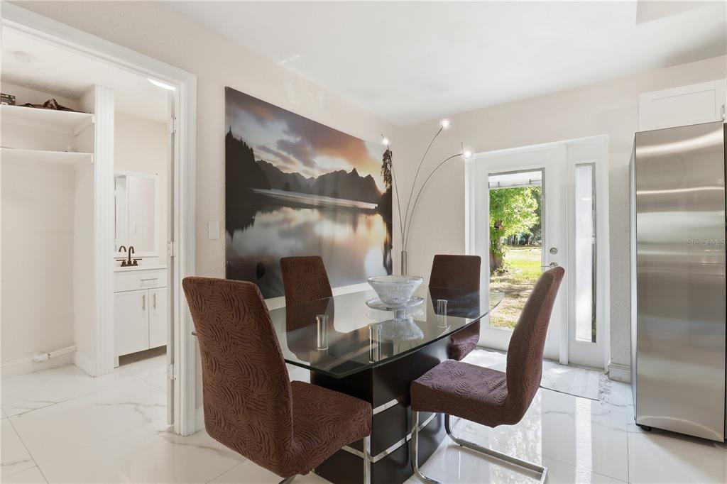 67 Cove Road Inglis, FL 34449 - Photo 11 of 35 a dining room with furniture and a floor to ceiling window