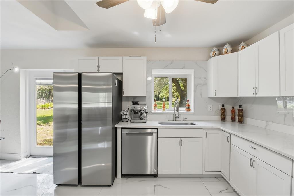 67 Cove Road Inglis, FL 34449 - Photo 14 of 35 a kitchen with a refrigerator sink and cabinets