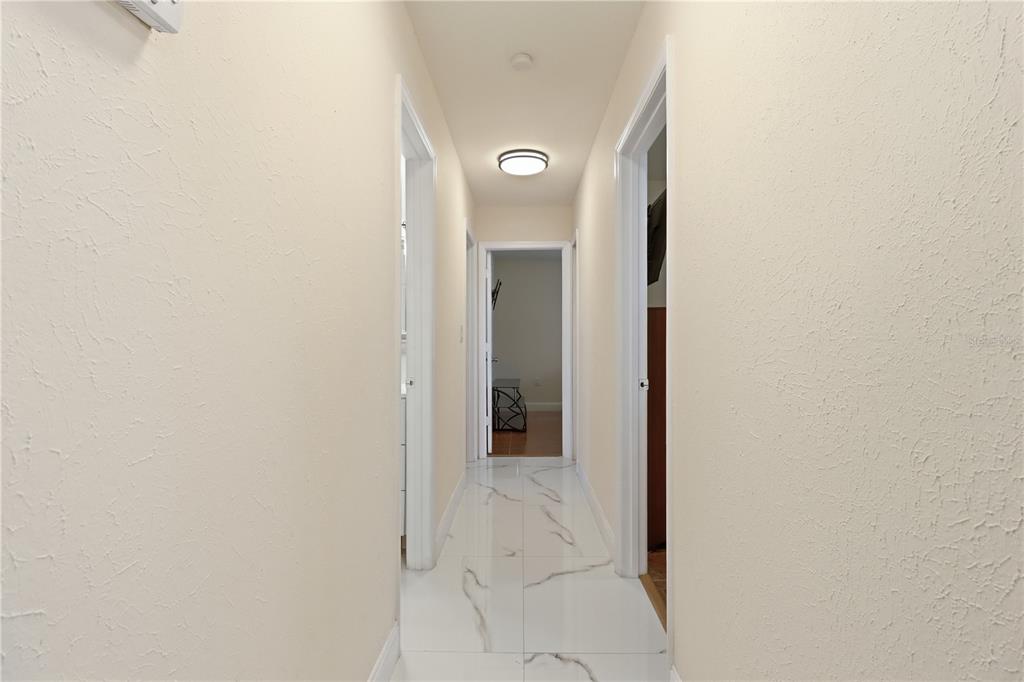 67 Cove Road Inglis, FL 34449 - Photo 18 of 35 a view of a hallway with wooden floor and a mirror