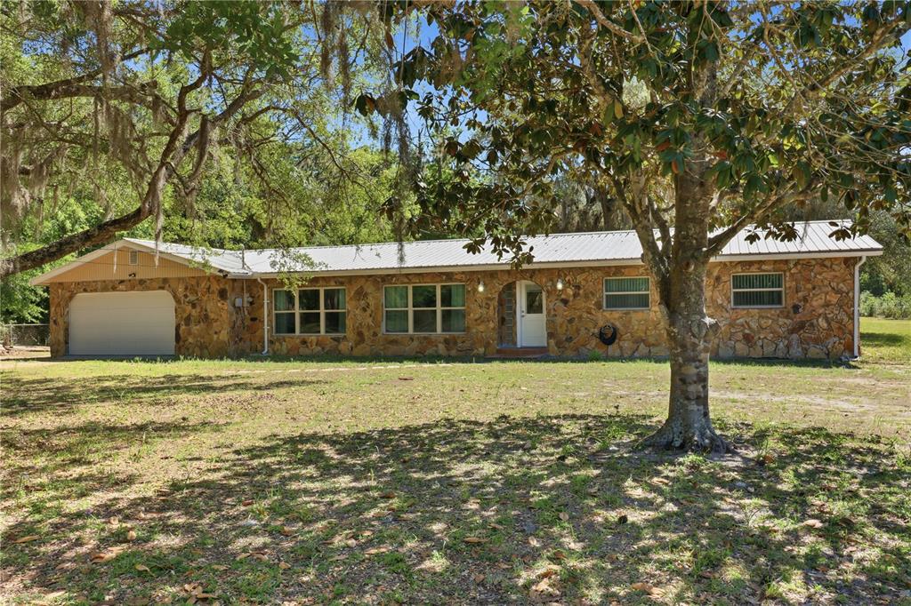 67 Cove Road Inglis, FL 34449 - Photo 2 of 35 a front view of a house with a yard