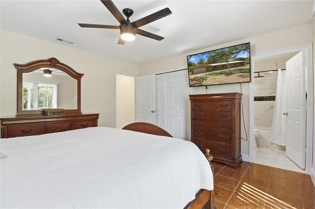 67 Cove Road Inglis, FL 34449 - Photo 23 of 35 a bedroom with a bed dresser and a window