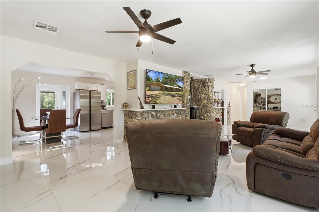67 Cove Road Inglis, FL 34449 - Photo 8 of 35 a living room with furniture and a ceiling fan