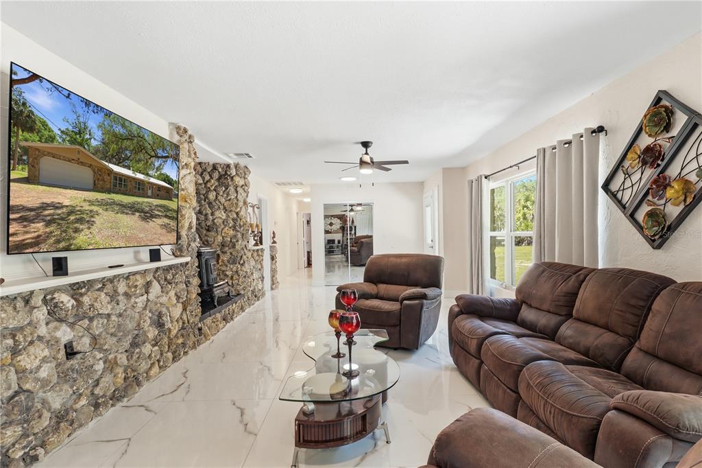 67 Cove Road Inglis, FL 34449 - Photo 9 of 35 a living room with furniture and a flat screen tv