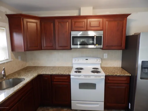 a kitchen with a sink stove and microwave