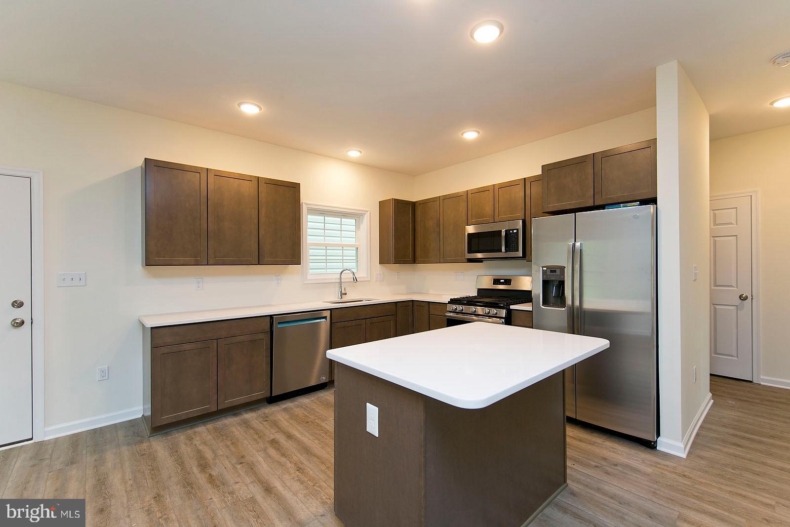 320 Pine Grove Road Bluemont, VA 20135 - Photo 6 of 28 a kitchen with a refrigerator a sink and cabinets