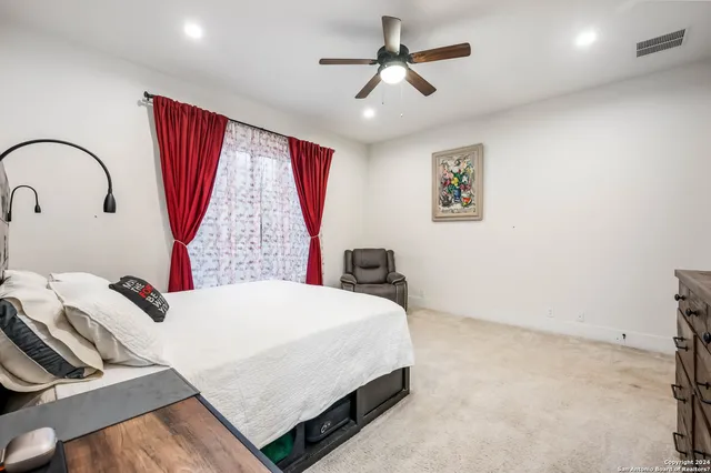 a bedroom with a bed and a large window