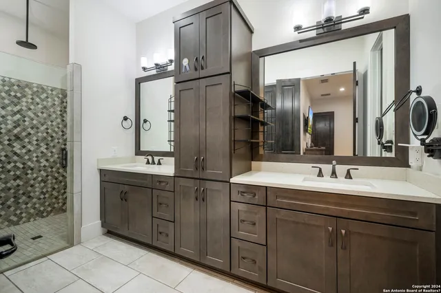 a bathroom with a double vanity sink mirror and double