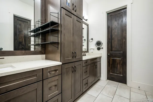 a bathroom with a sink a mirror and a shower