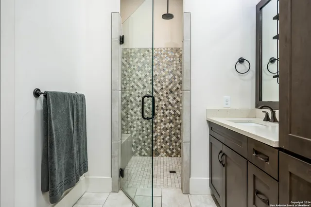 a bathroom with a shower and a sink