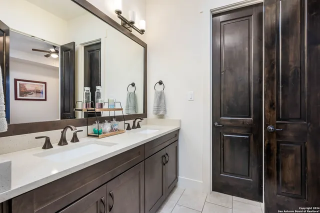 a bathroom with a double vanity sink and mirror