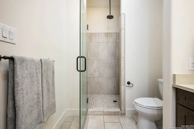 a bathroom with a toilet and shower