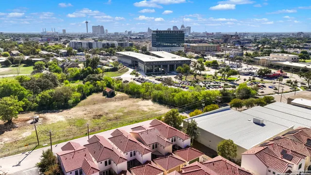 an aerial view of a residential apartment building with a yard