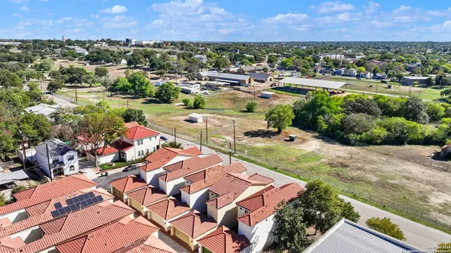 an aerial view of a houses and city street