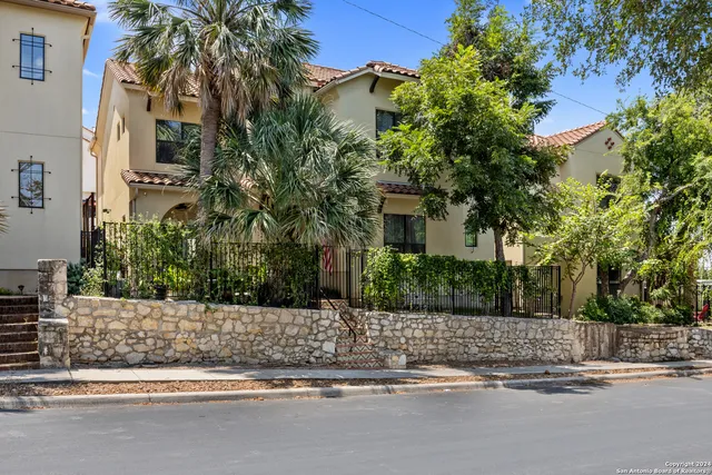 a house that has a tree in front of it