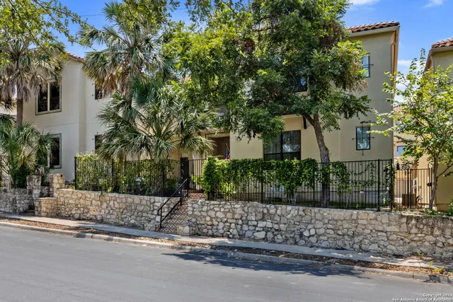 front view of a house with a tree