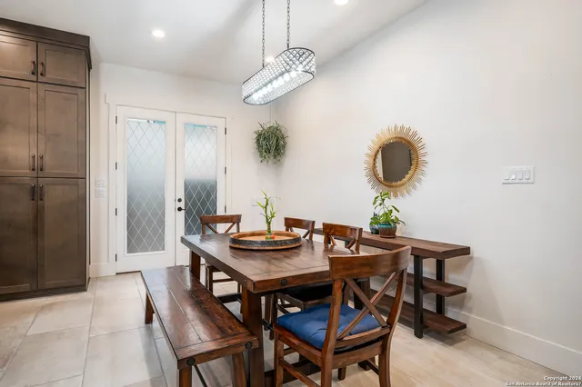 a view of a dining room with furniture and chandelier