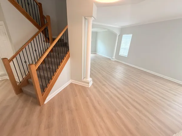a view of an entryway with wooden floor