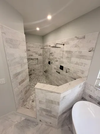 a bathroom with a bathtub and shower