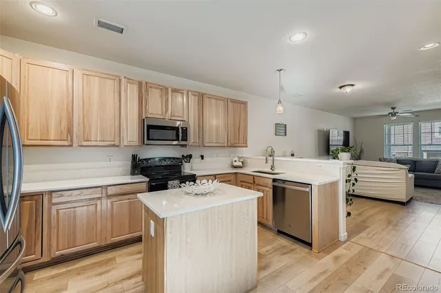 a kitchen with cabinets a sink and appliances