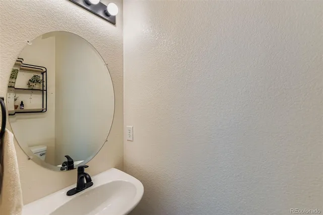 a bathroom with a sink and mirror