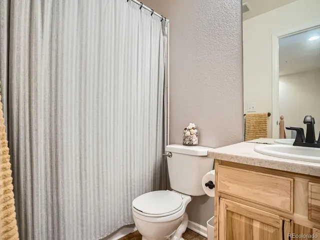 a bathroom with a toilet a sink and a window
