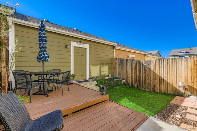 a view of a chairs and table on the wooden deck